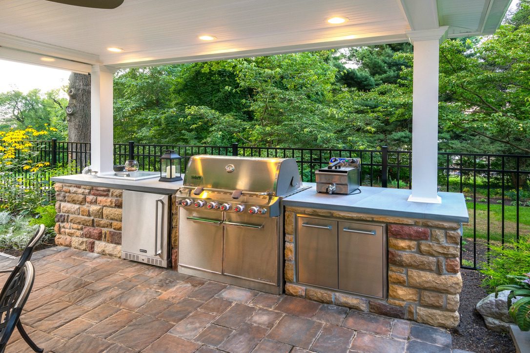 A patio with an outdoor kitchen and grill.
