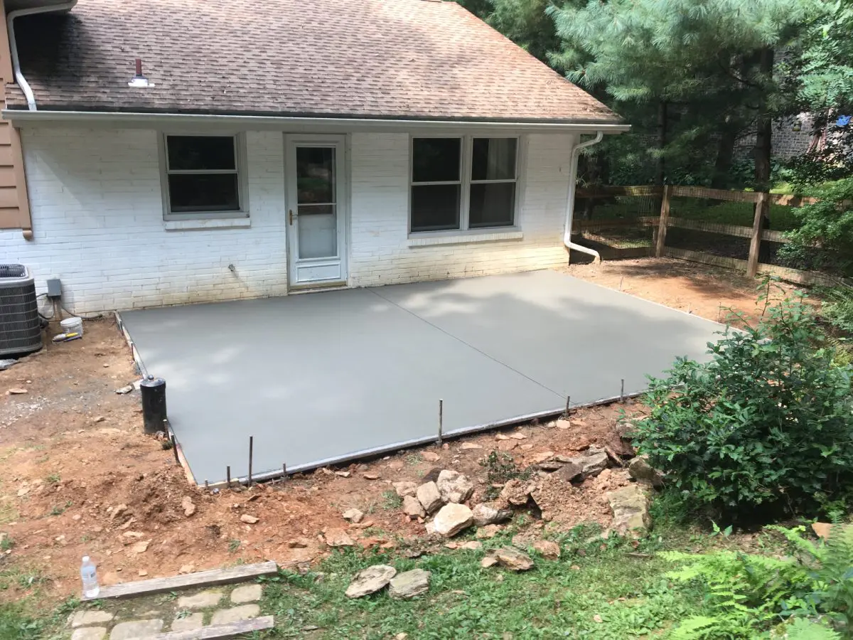 A concrete slab is being poured for the patio.