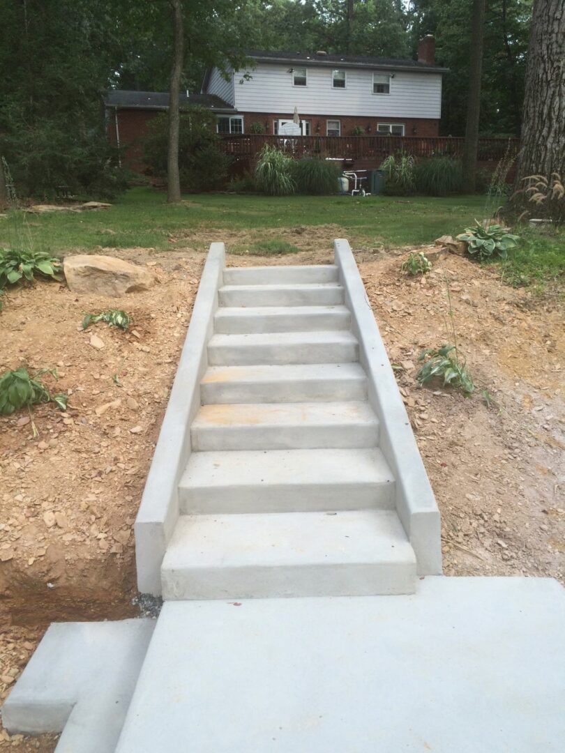 A concrete staircase in the middle of a yard.