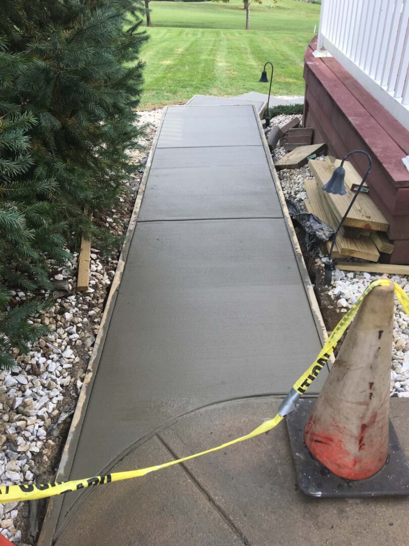 A walkway with cement on the side of it.