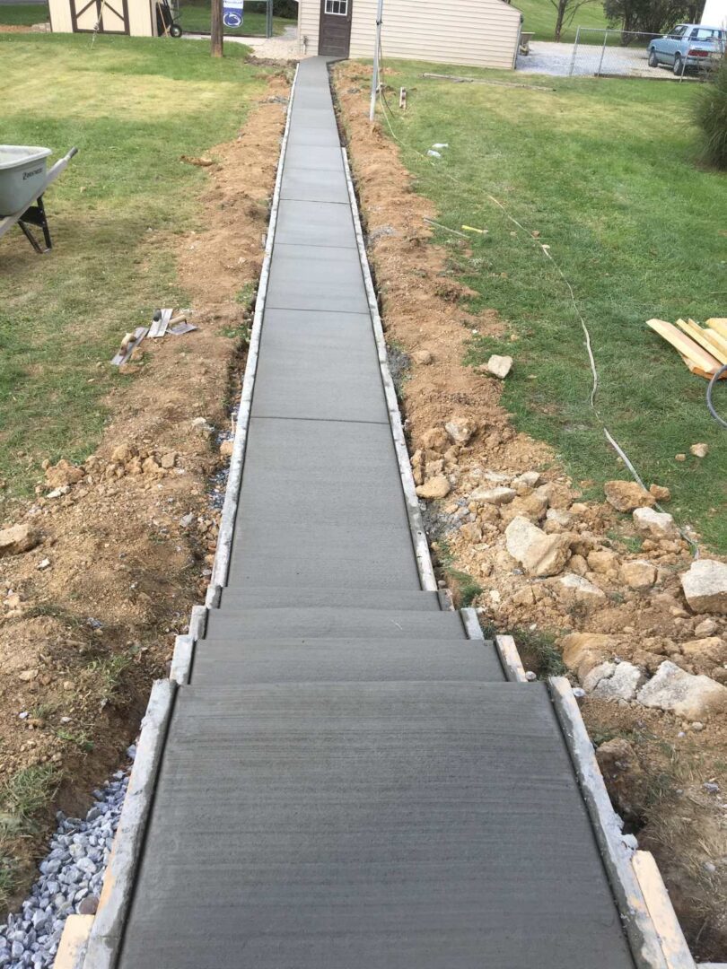 A walkway is being built in the middle of a field.