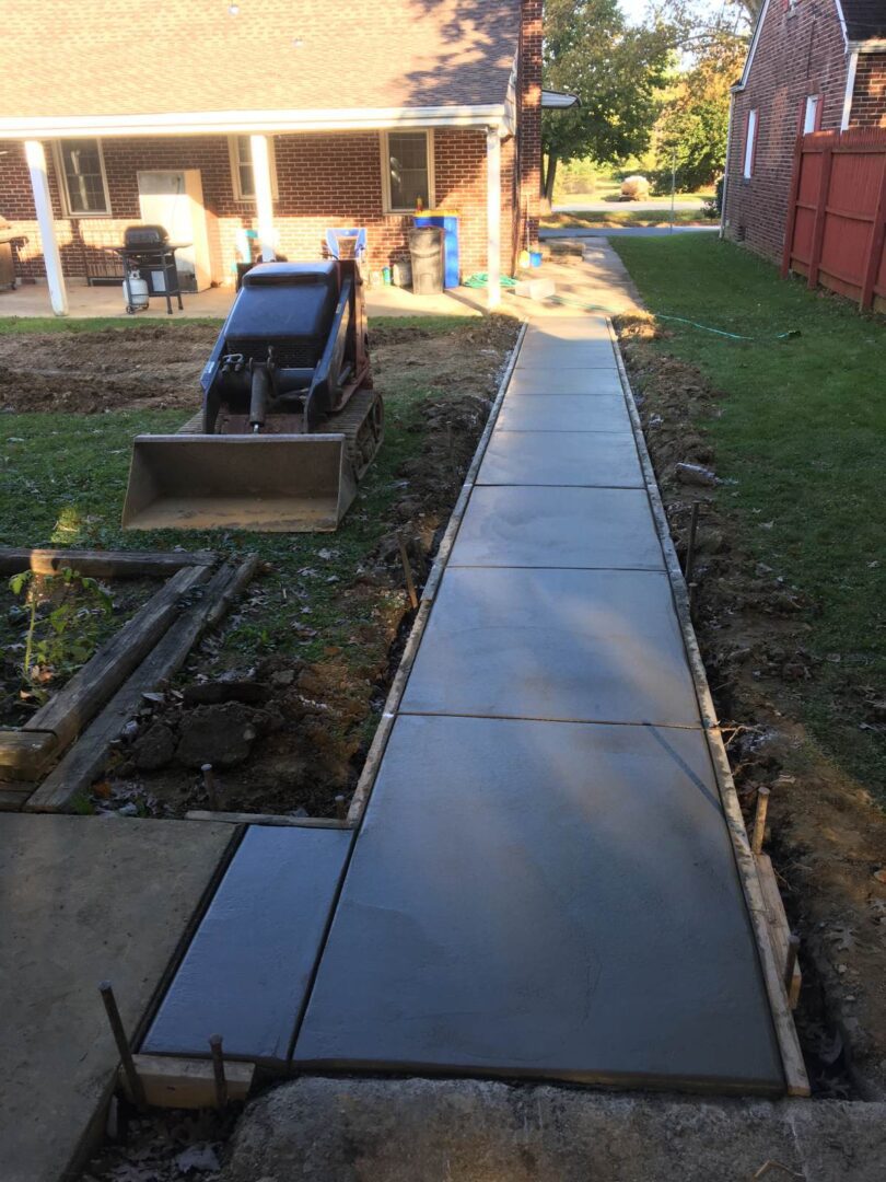 A walkway is being built in the yard.