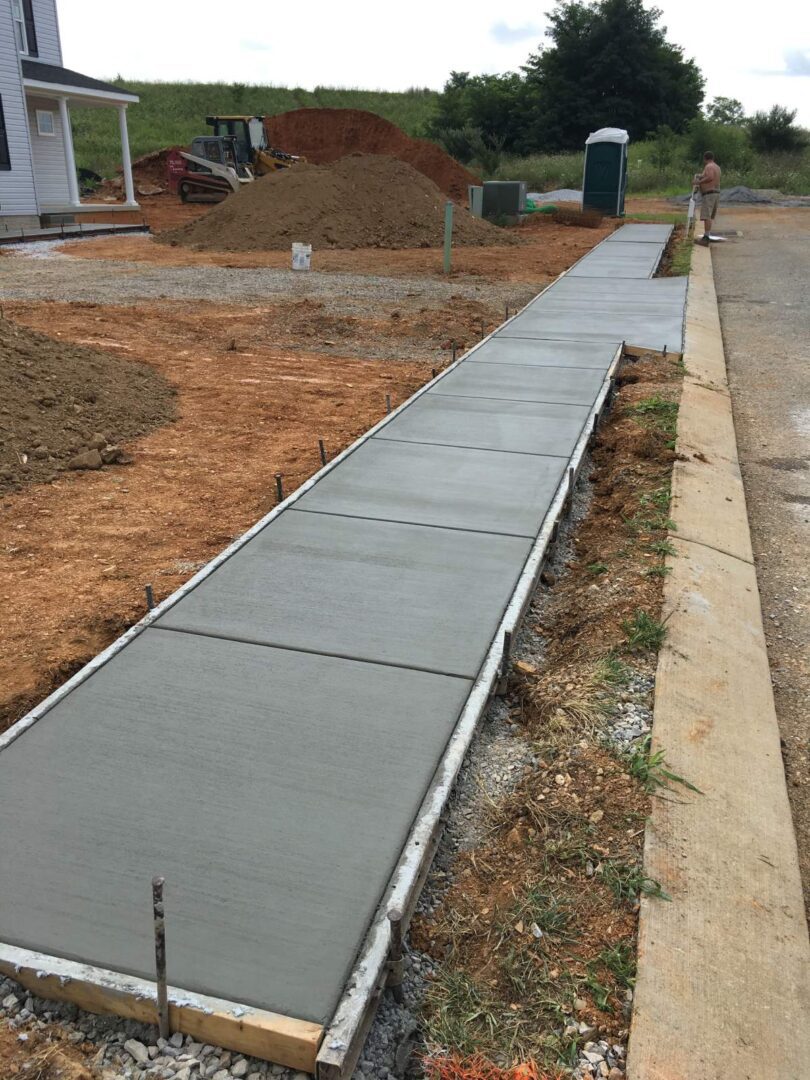 A sidewalk that has been laid out and is being poured.