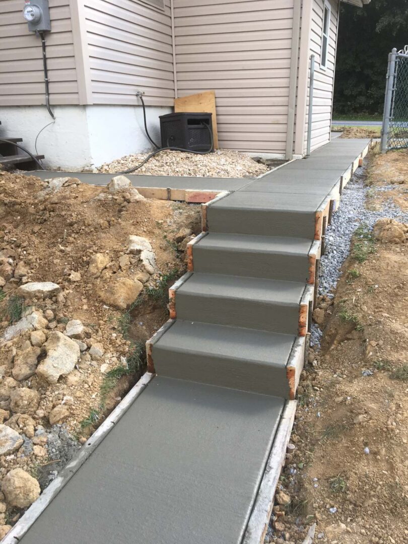 A concrete walkway with steps leading to the ground.