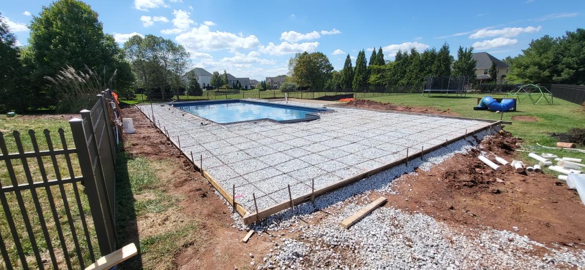 A pool being built in the middle of a field.