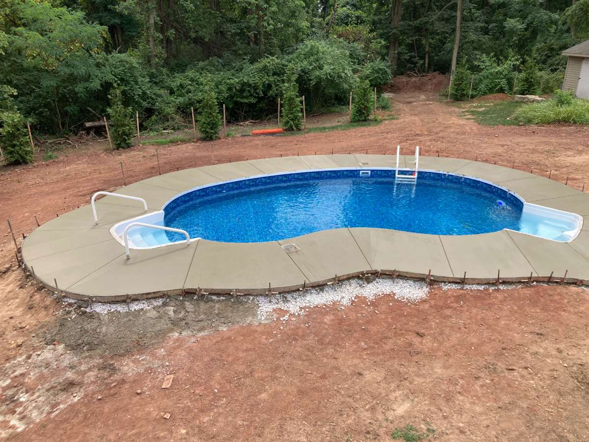 A pool that is in the ground with no people around it.