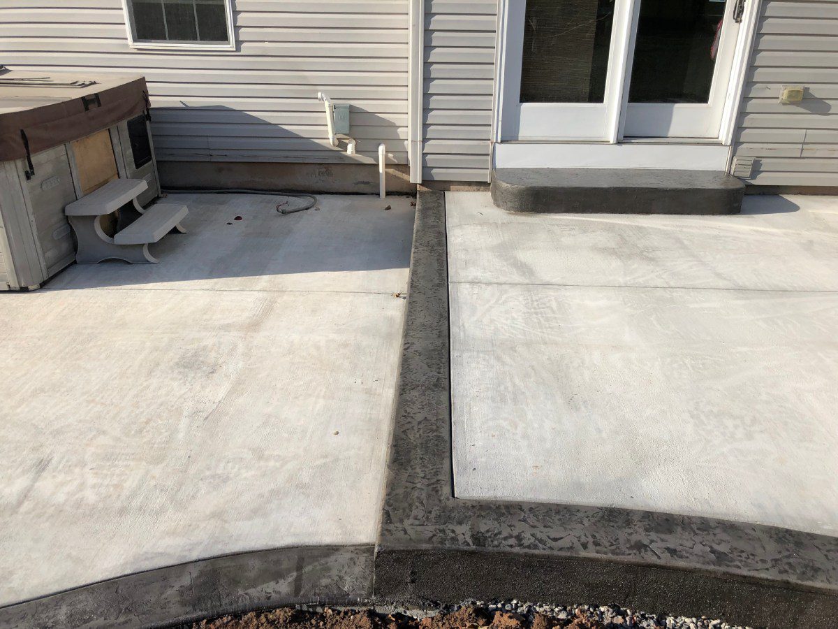 A concrete patio with two different colored borders.