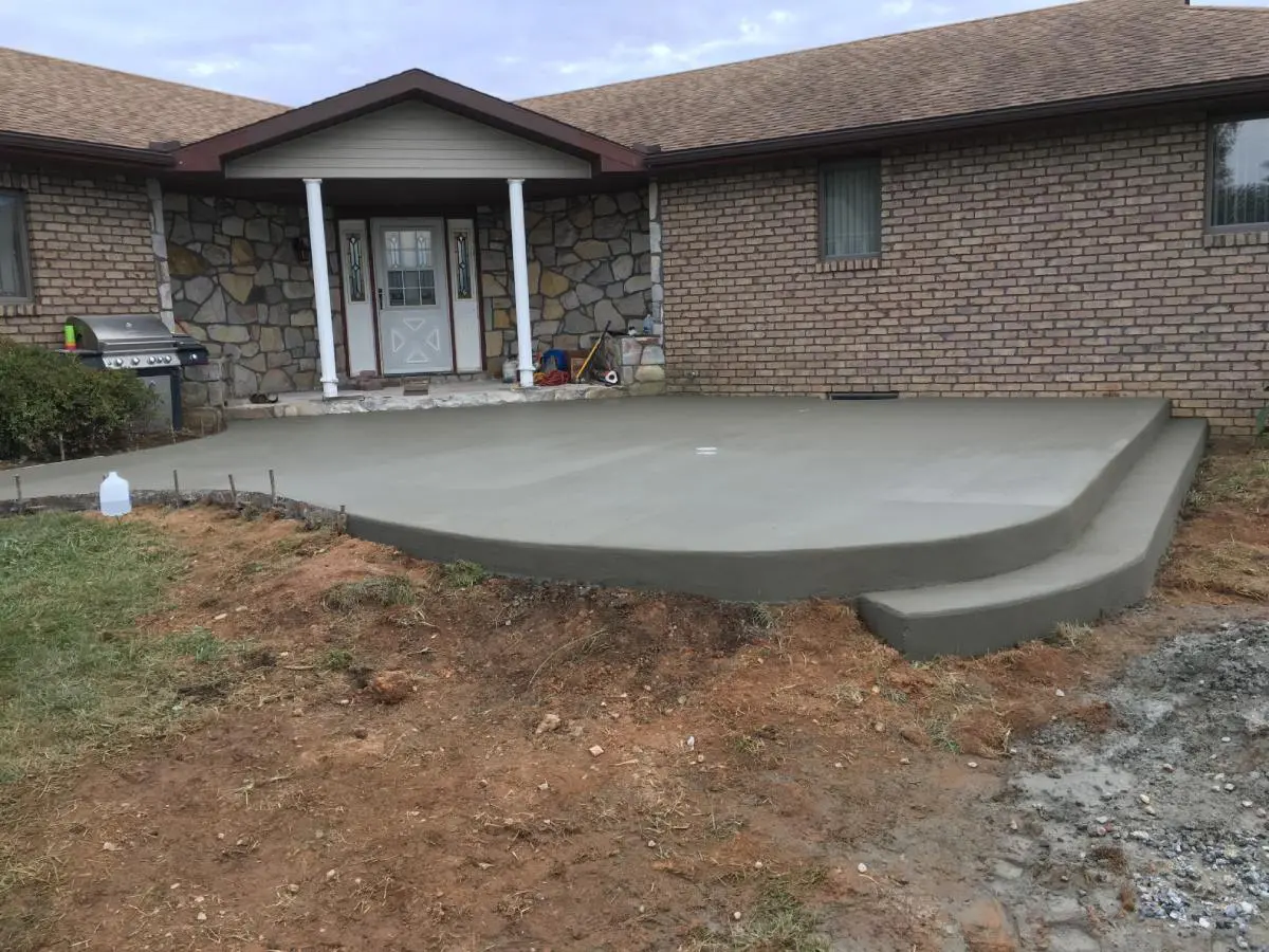 A concrete slab sitting in front of a house.