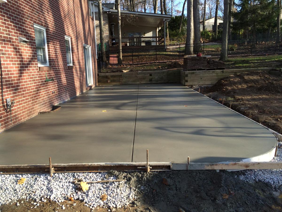 A concrete slab is being poured for the driveway.