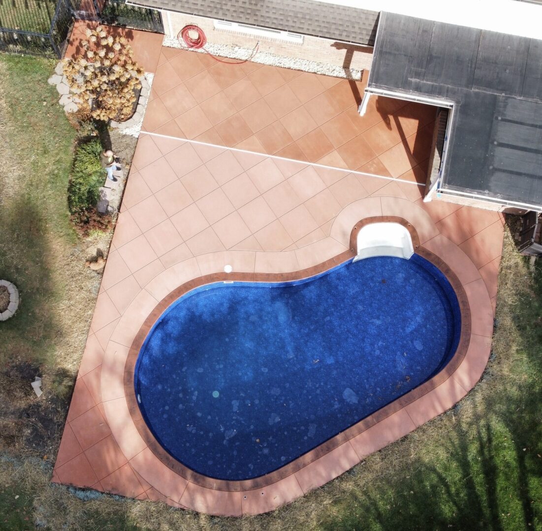 An aerial view of a pool with a roof over it.