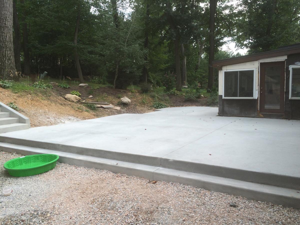 A concrete slab with steps leading to the ground.